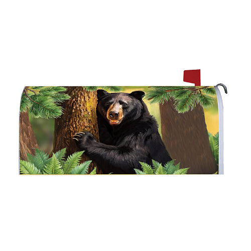 Mailbox cover with a bear design in a forest setting
