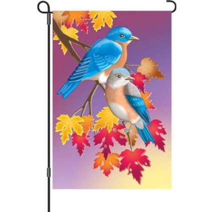 Decorative garden flag with two blue birds on a branch with colorful leaves.