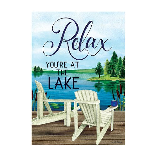 Decorative sign with 'Relax, You're at the Lake' text over a painting of a lake scene with chairs.