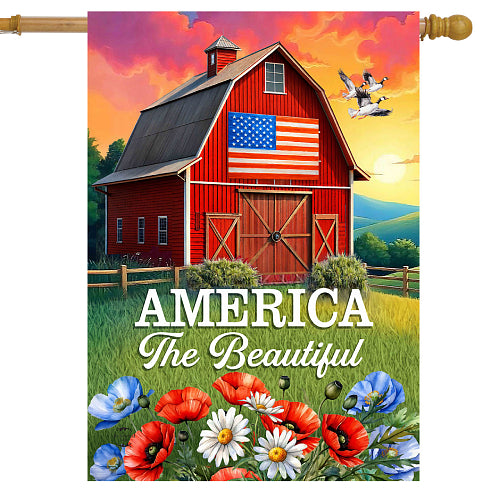 Decorative flag with a red barn, American flag, and 'America The Beautiful' text against a colorful sky.