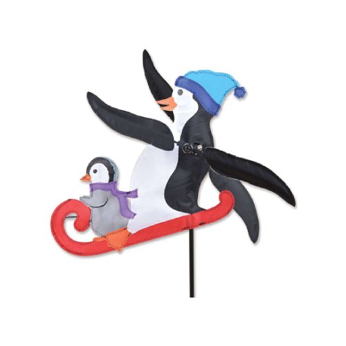 A penguin-themed garden stake decoration featuring a large black-and-white penguin wearing a blue hat and a smaller gray-and-white penguin in a red sled, shown on a plain white background.