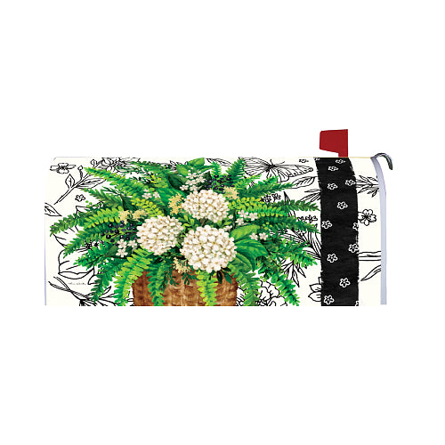 Decorative mailbox cover with floral design and a basket of flowers on a white background
