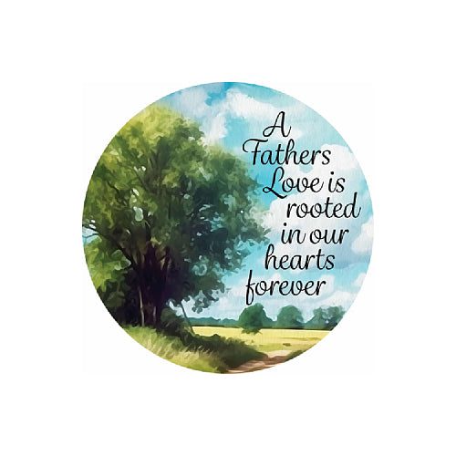 A circular watercolor-style print featuring a green tree, blue sky with clouds, and a small field, with the text 'A Fathers Love is rooted in our hearts forever' in black script on the right side.