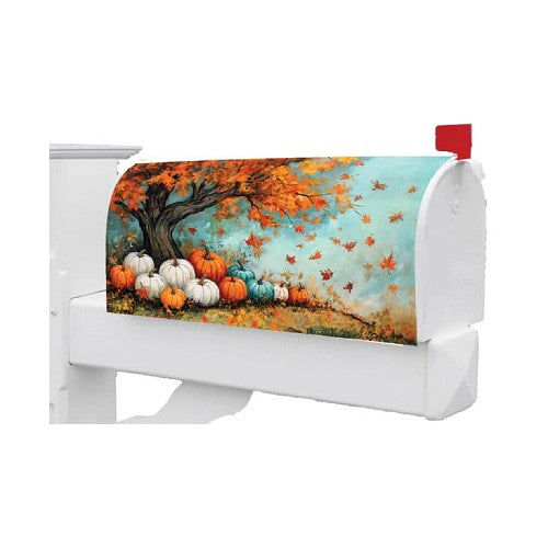 White mailbox with a colorful autumn-themed cover featuring pumpkins and trees.