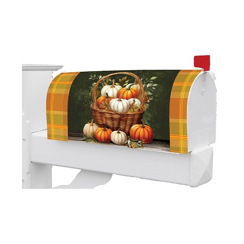 Decorative fall mailbox cover featuring pumpkins and a basket on a white background