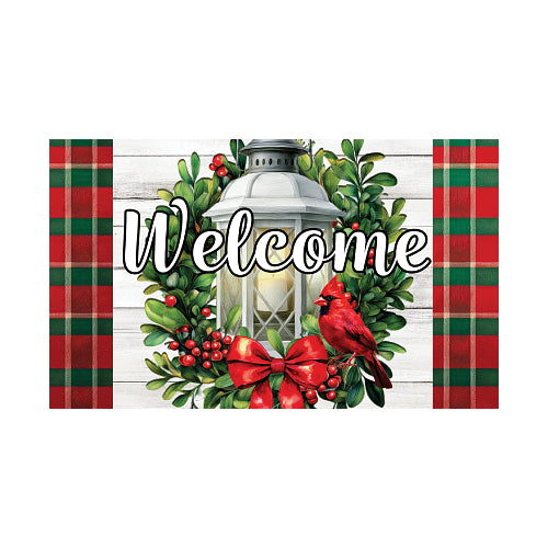 Decorative doormat with a lantern, cardinal, and wreath on a barn wood background with red and green plaid borders.