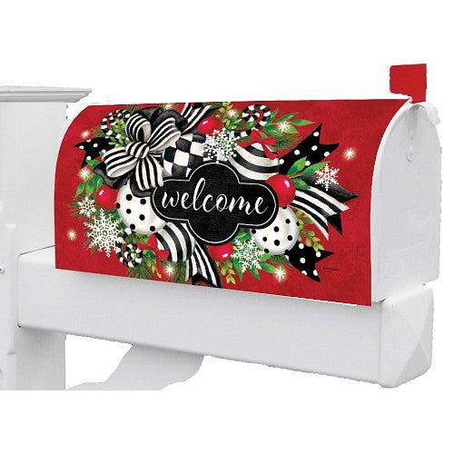 Decorative, large mailbox cover with festive design featuring a bow, snowflakes, and the word 'welcome' on a red background.