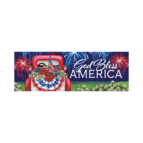 Decorative sign with 'God Bless America' text, red car, American flag, and fireworks on a night background.