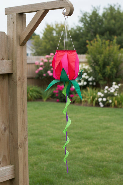 ROSE Spinning Windsock - Red rosebud-shaped garden spinner with spiral tail shown hanging outdoors