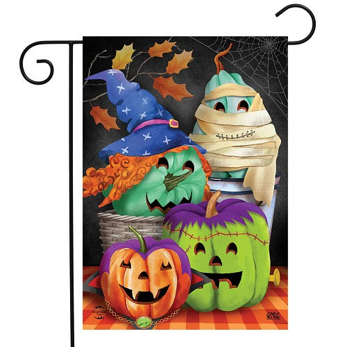 Spooky, but fun ja ck o_lanterns dressed in a witches hat, a mummy, vampire and as Frankentein