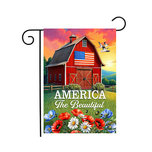 Decorative flag with a red barn, American flag, and 'America The Beautiful' text on a colorful background.