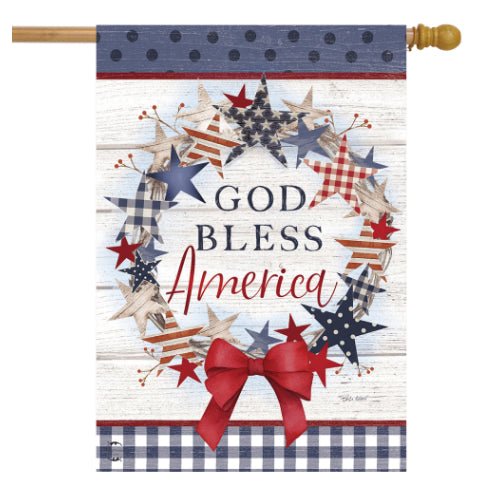 Decorative flag with stars, a bow, and 'God Bless America' text on a wooden background.