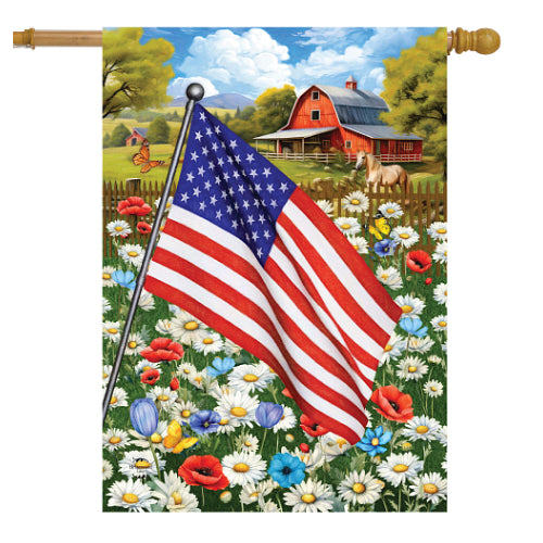 American flag in a field of flowers with a barn and landscape in the background