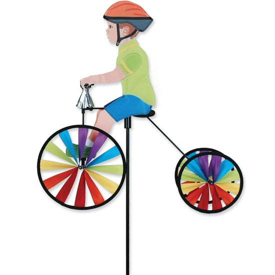 Boy riding a colorful tricycle outdoor wind spinner made with UV-resistant SunTex fabric