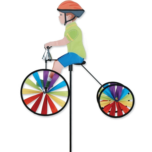 Boy riding a colorful tricycle outdoor wind spinner made with UV-resistant SunTex fabric
